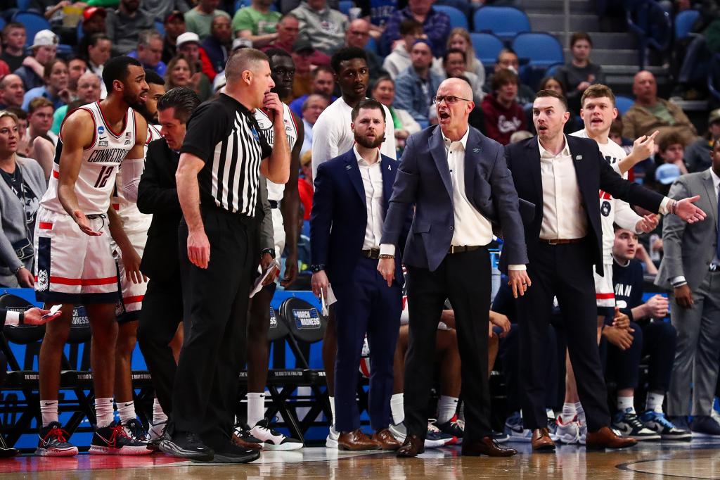 Connecticut Huskies coaching staff reacts towards a game official as they play against New Mexico State Aggies in the first round of the 2022 NCAA Men's Tournament.