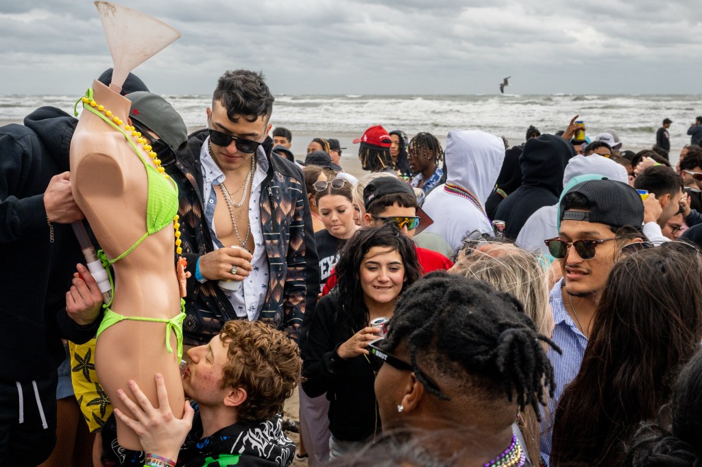 Students were seen taking shots from a glass that was inserted into a bikini bottom tied to a life-size store mannequin. 