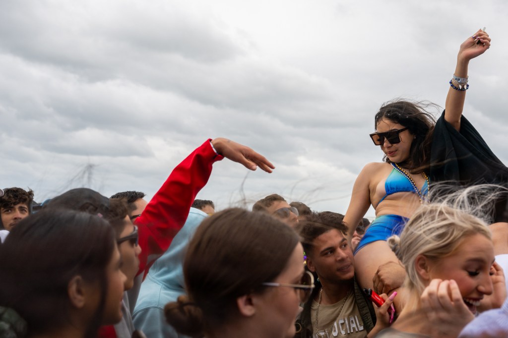 Despite the blustery conditions, many of the college students stripped down to their skimpy swimwear to show off their spring break bodies.