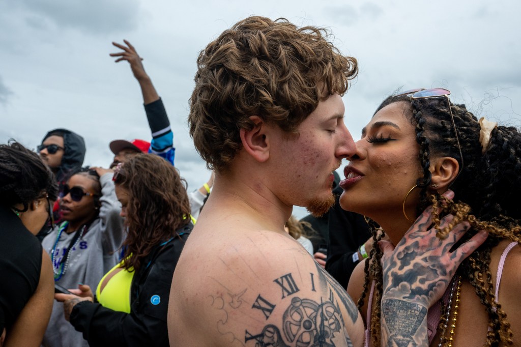 Young love: Several passionate party animals were seen smooching on the sand.