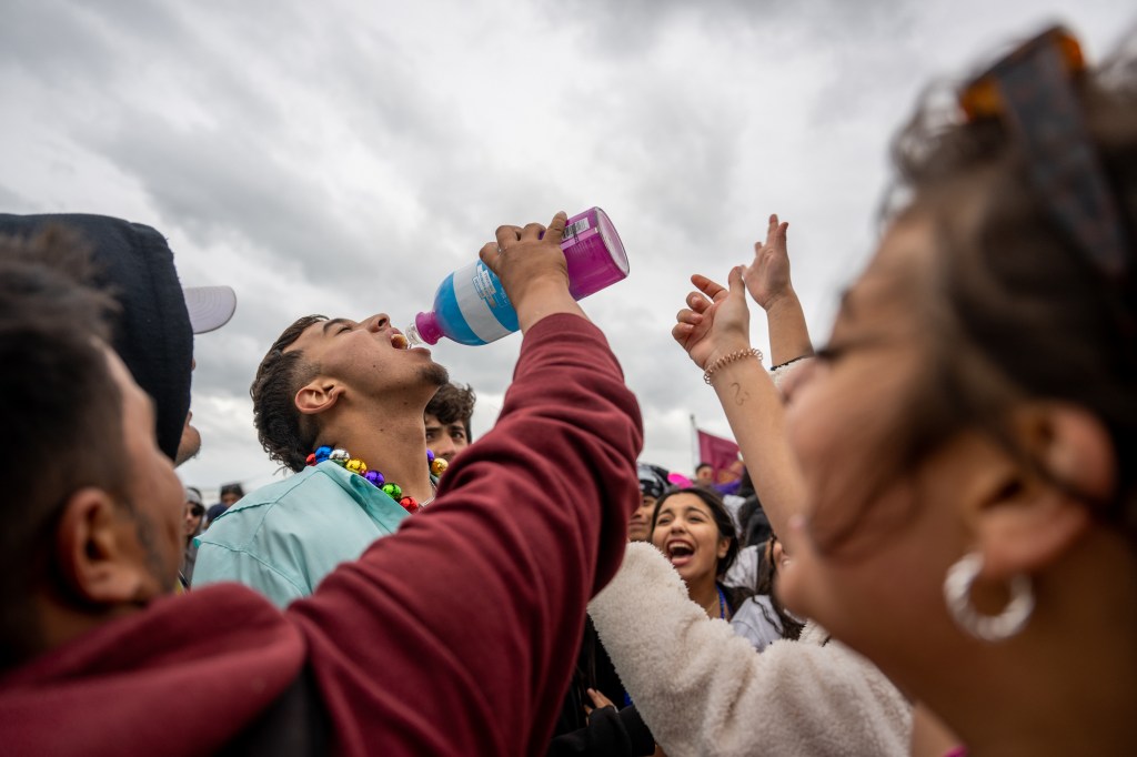 One student was seen drinking liquor squeezed into his mouth by another reveler. 