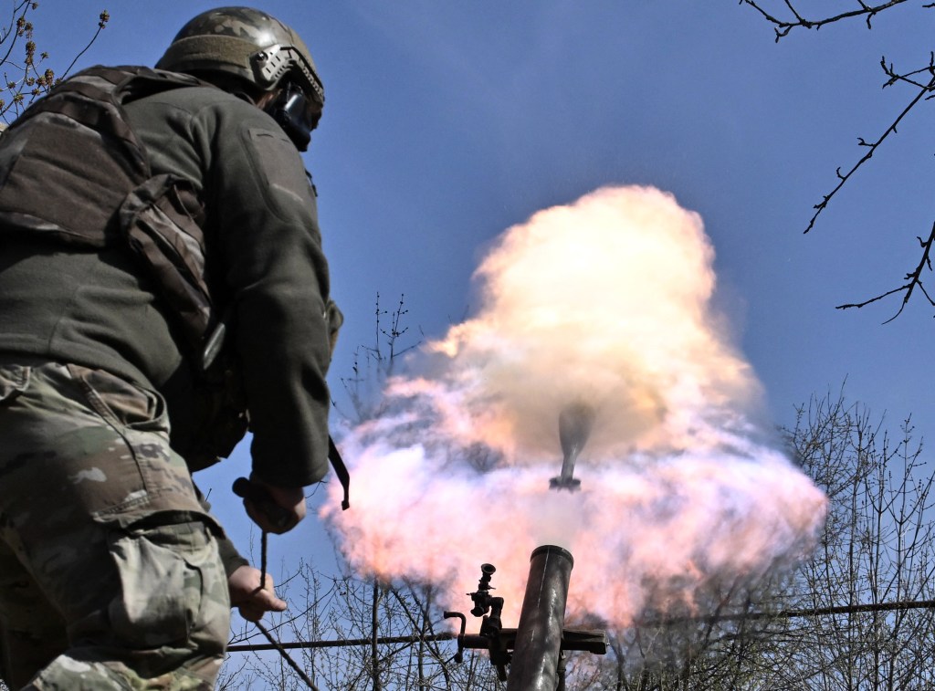 A Belarusian volunteer soldier from the Kastus Kalinouski regiment, a regiment made up of Belarusian opposition volunteers formed to defend Ukraine, fires a 120mm mortar round at a front line position near Bakhmut in the Donetsk region on April 9, 2023. 