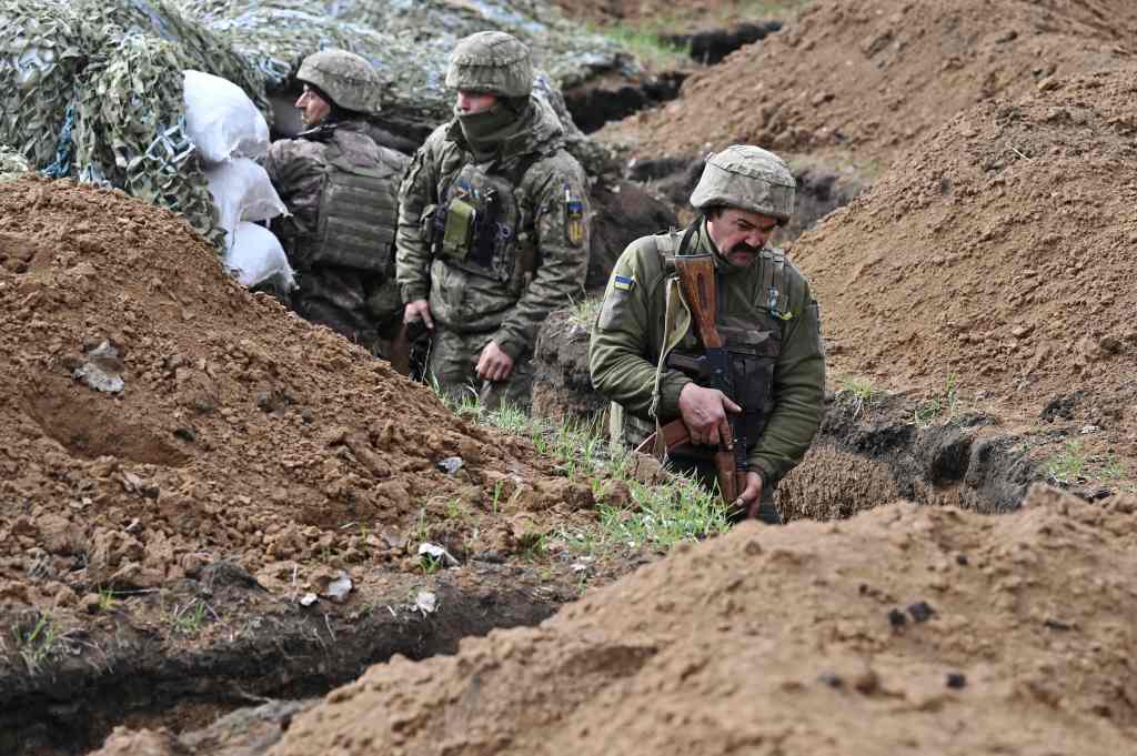 Ukrainian servicemen stand in a trench near their position near the town of Bakhmut, Donetsk region on April 8, 2023. 