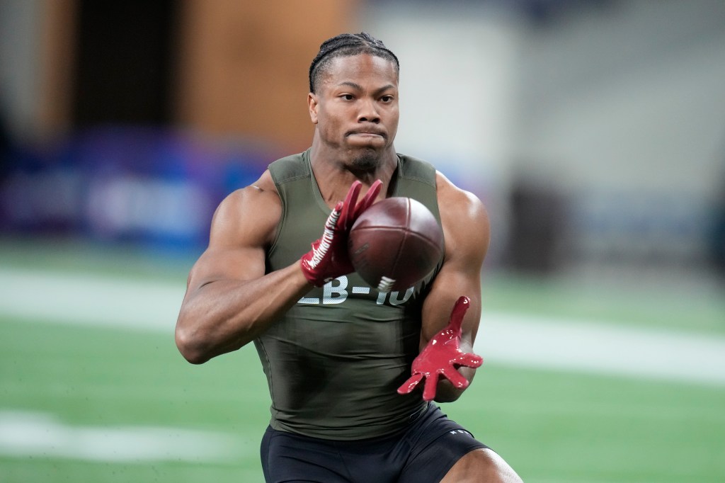 Daiyan Henley catches the ball during an NFL Combine drill.