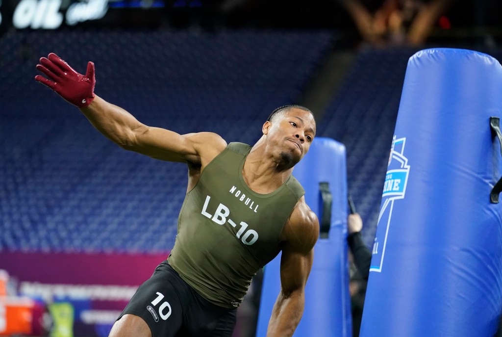 Daiyan Henley runs a drill during the NFL Combine earlier this year.