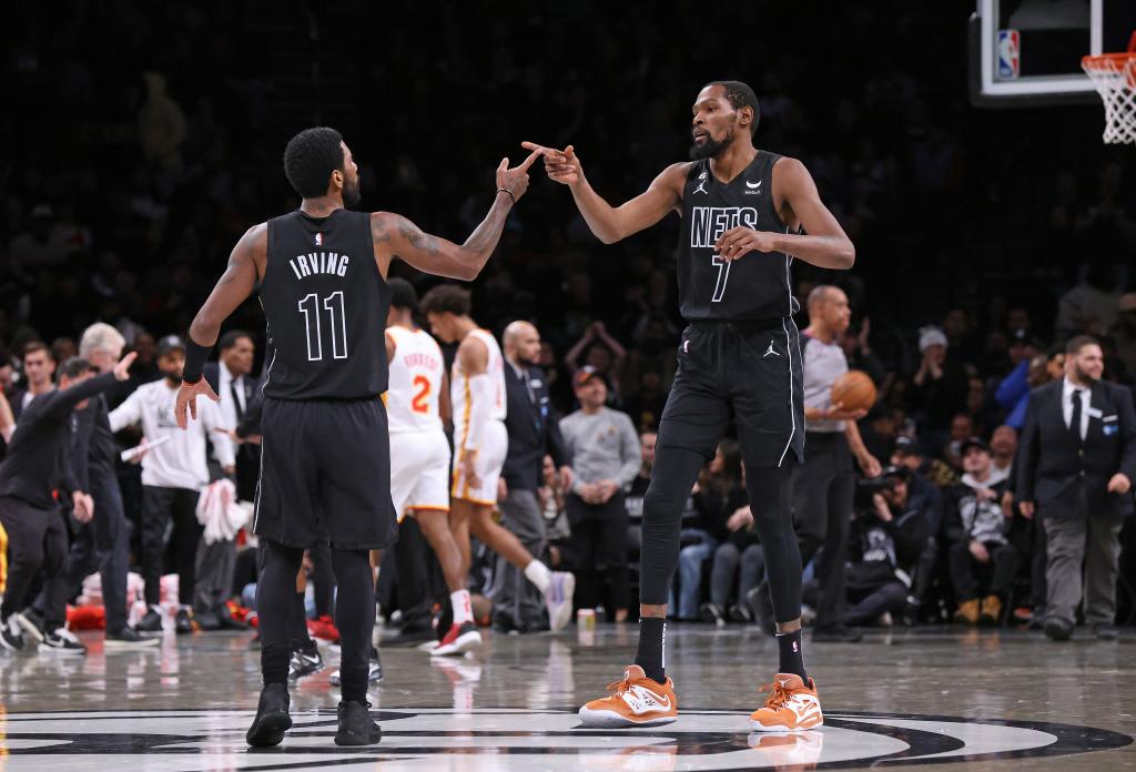 Kyrie Irving and Kevin Durant celebrate during a Nets game in December 2022.