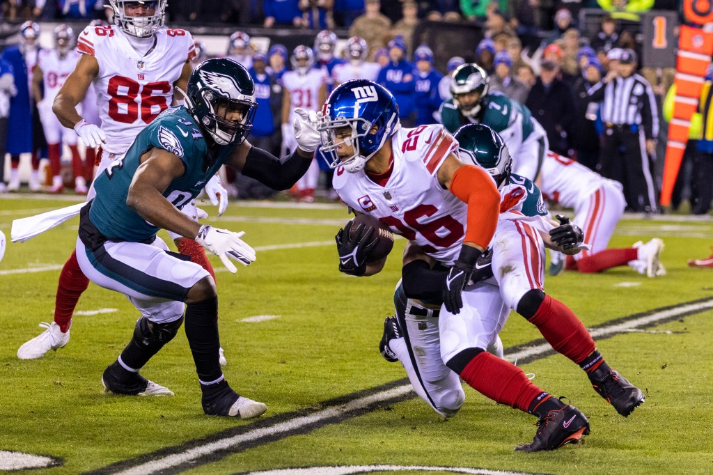 Saquon Barkley runs the ball during the first half in the NFC Divisional playoffs.