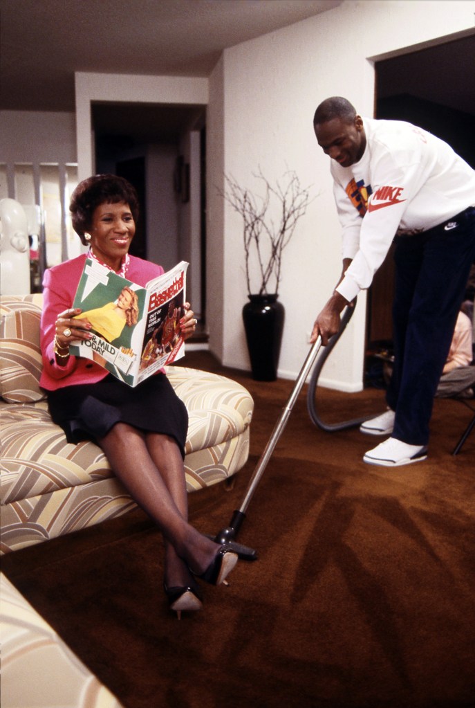 Michael Jordan flexes his vacuuming skills as his mother Deloris relaxes. 