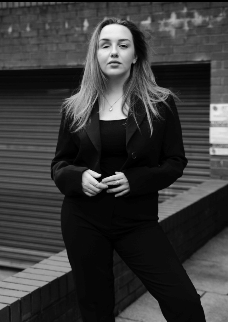 Black and white photo of woman with blonde hair.