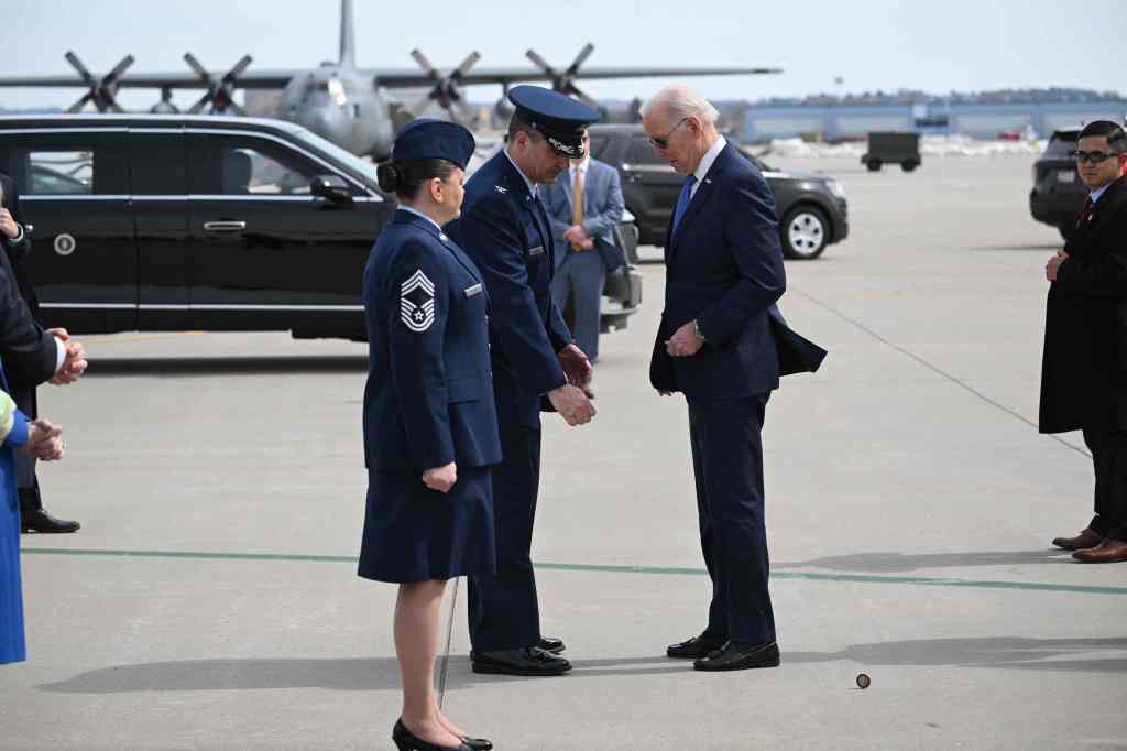 President Biden drops a challenge coin after landing at Minneapolis-Saint Paul International Airport Monday, April 3, 2023. 