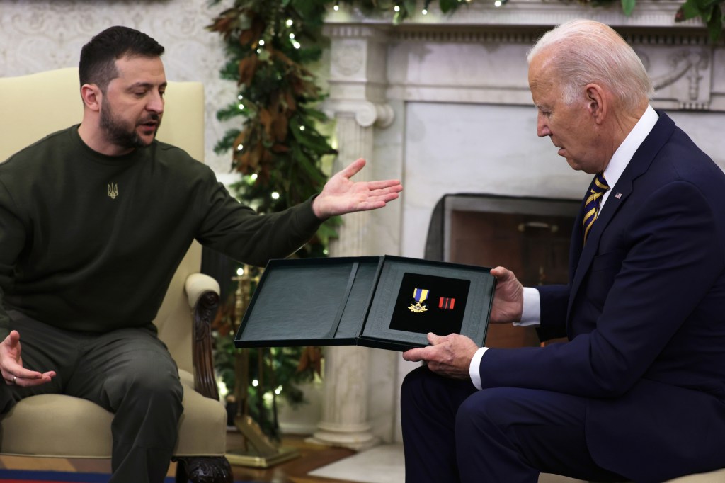 Biden accepts a military medal from Ukraine President Volodymyr Zelensky on Dec. 21, 2022.