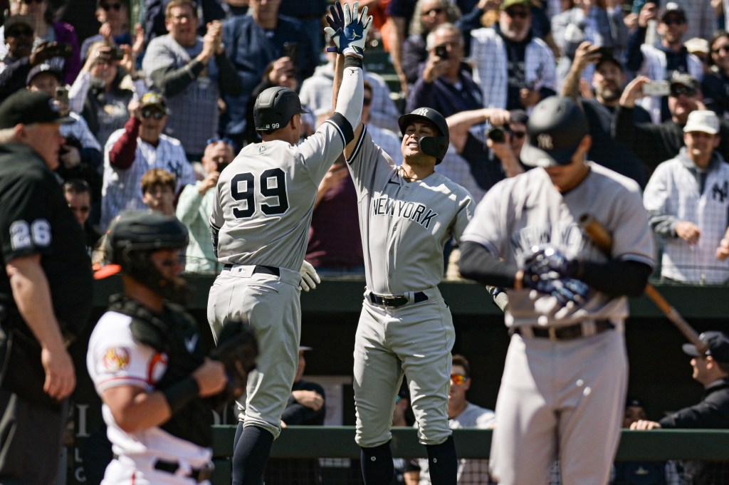 Aaron Judge (99) celebrates his first home run of the day with Giancarlo Stanton on April 9, 2023.