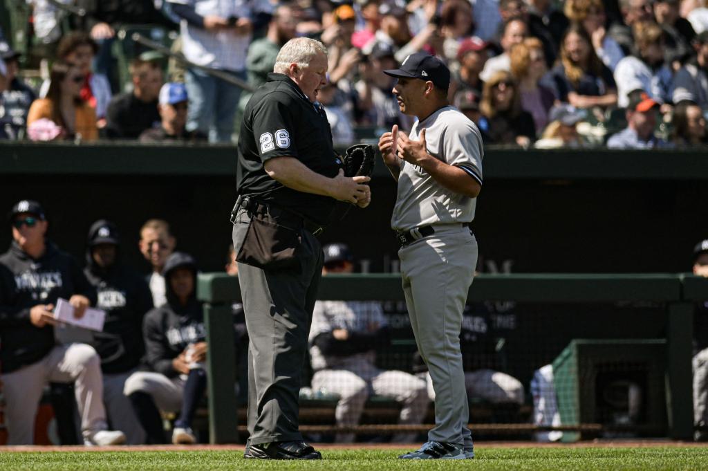 Yankees pitcher Nestor Cortes talks to home plate umpire Bill Miller after the first inning.