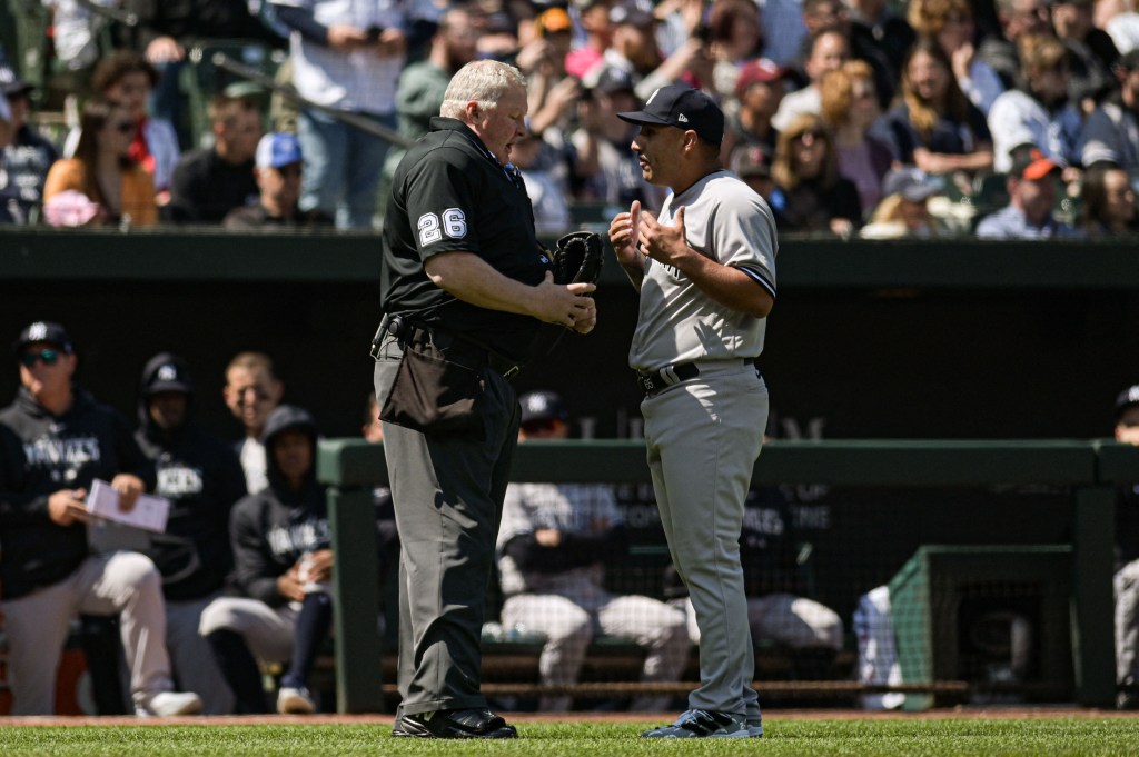 Yankees pitcher Nestor Cortes talks to home plate umpire Bill Miller after the first inning.