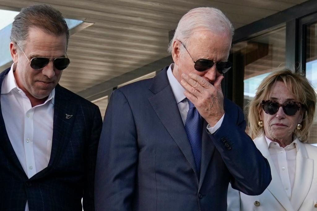 President Joe Biden stands with his son Hunter Biden, left.