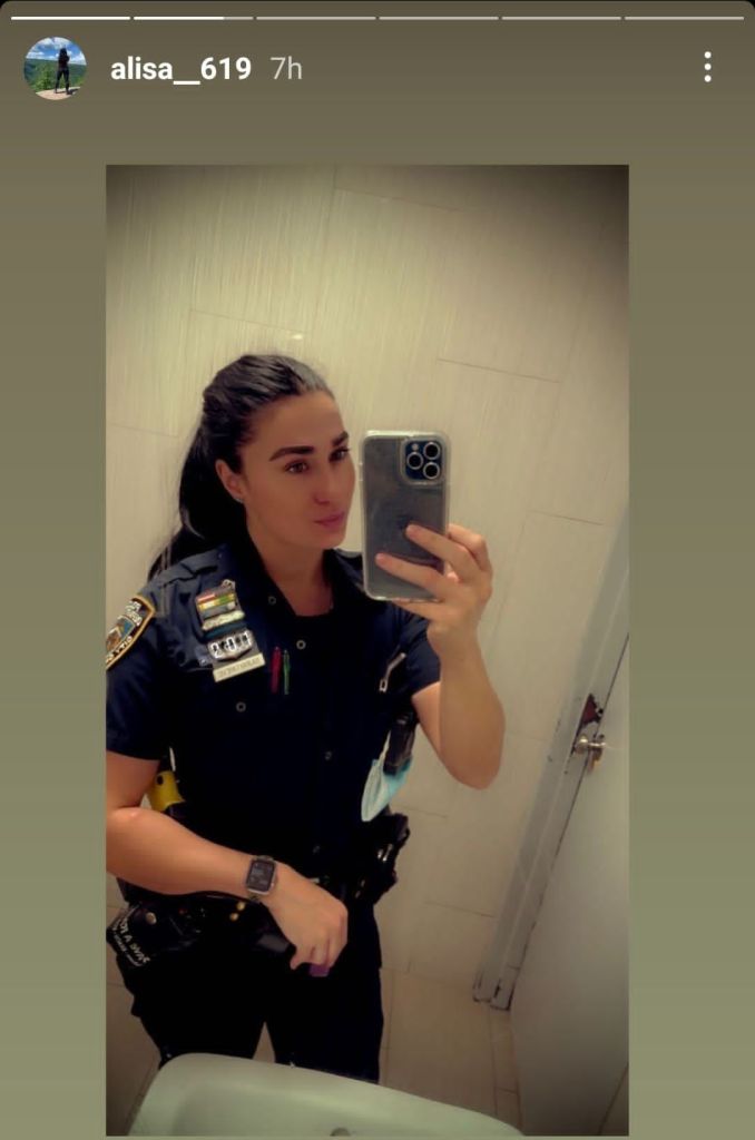 Police officer takes a bathroom selfie.