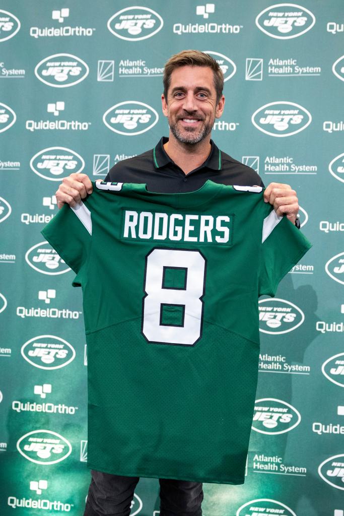 Aaron Rodgers holding his No. 8 Jets jersey on April 26, 2023.