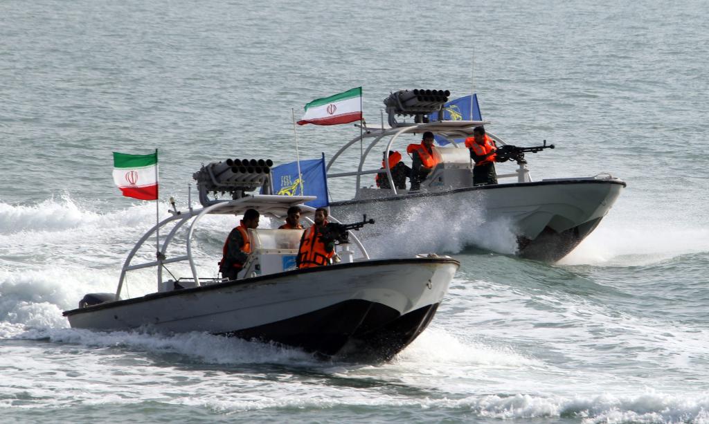 Iranian Revolutionary Guards drive speedboats during a ceremony to commemorate the 24th anniversary of the downing of Iran Air flight 655 by the US navy.