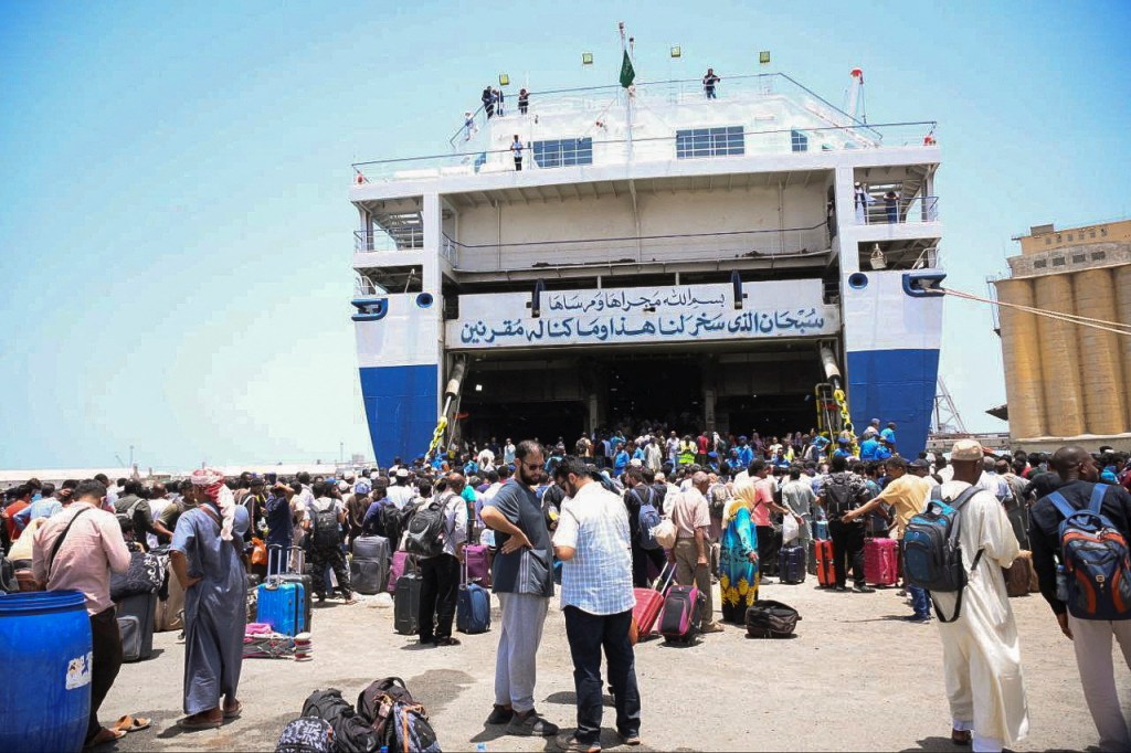 European, Asian and African nationals prepare to board a ship to Saudi Arabia on Thursday.