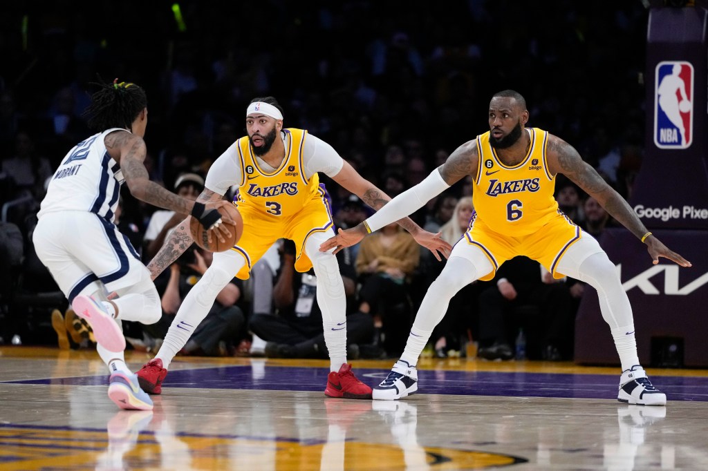 Lakers' LeBron James and Anthony Davis defend against Memphis Grizzlies' Ja Morant.