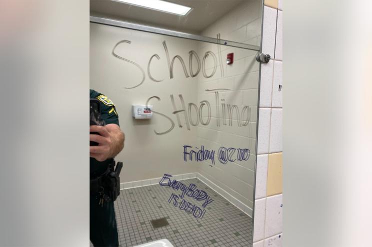 Graffiti on school bathroom mirror