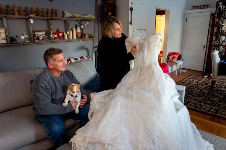 Caroline Wilcox, a Portland, Connecticut resident, accompanied by her brother, Roger Johnson, admires the wedding dress their uncle, Karl Lagerfeld both made and had.