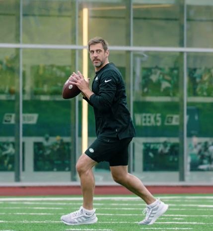 Aaron Rodgers on the field at the Jets' training facility.