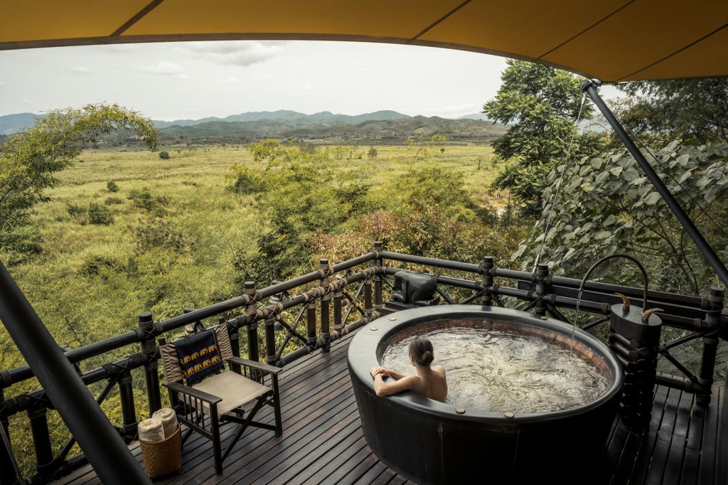 woman in hot tub in Africa in a treehouse 