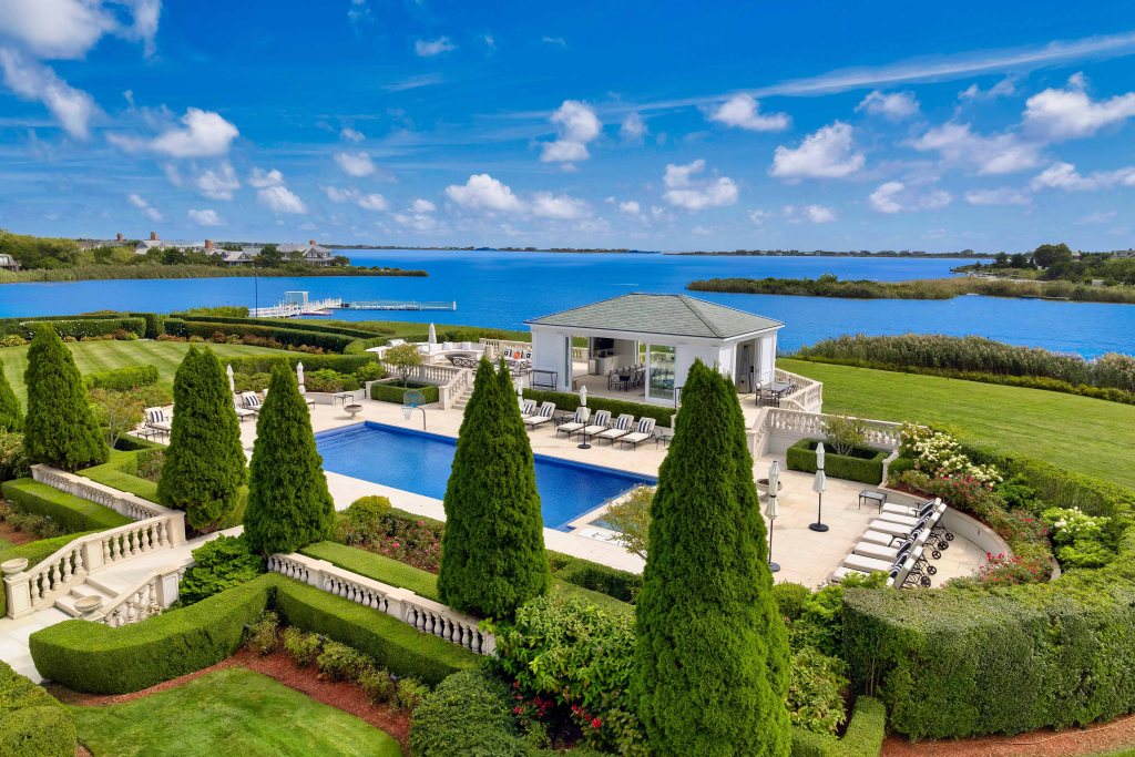 In Water Mill, a massive 13-bedroom mansion at 71 Cobb Lane, set on 9 sprawling acres overlooking Mecox Bay, is asking $59.95 million — a big slash from its $72 million ask last year.