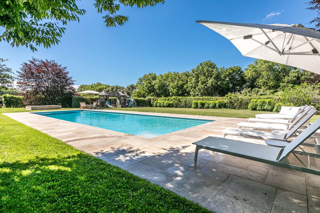 The 10,000-square-foot cedar-shingle stunner sits on 10 acres and boasts a pool.