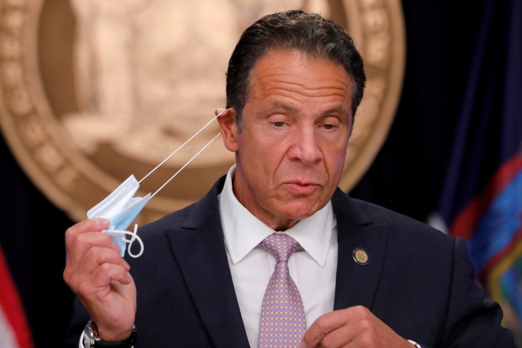 New York Governor Andrew Cuomo removes his protective face mask 