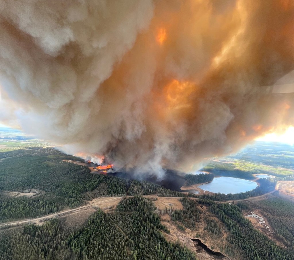 Smoke column rises from a wildfire near Lodgepole, Alberta