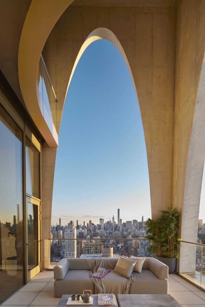 Covered outdoor space of the Upper East Side home that doubled as the apartment of Kendall Roy on "Succession," with dramatic arches framing views of New York City.