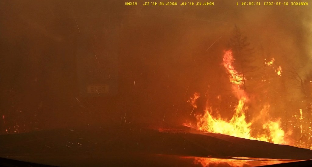 Smoke covers the road as wildfire burns in Hammonds Plains, Nova Scotia.