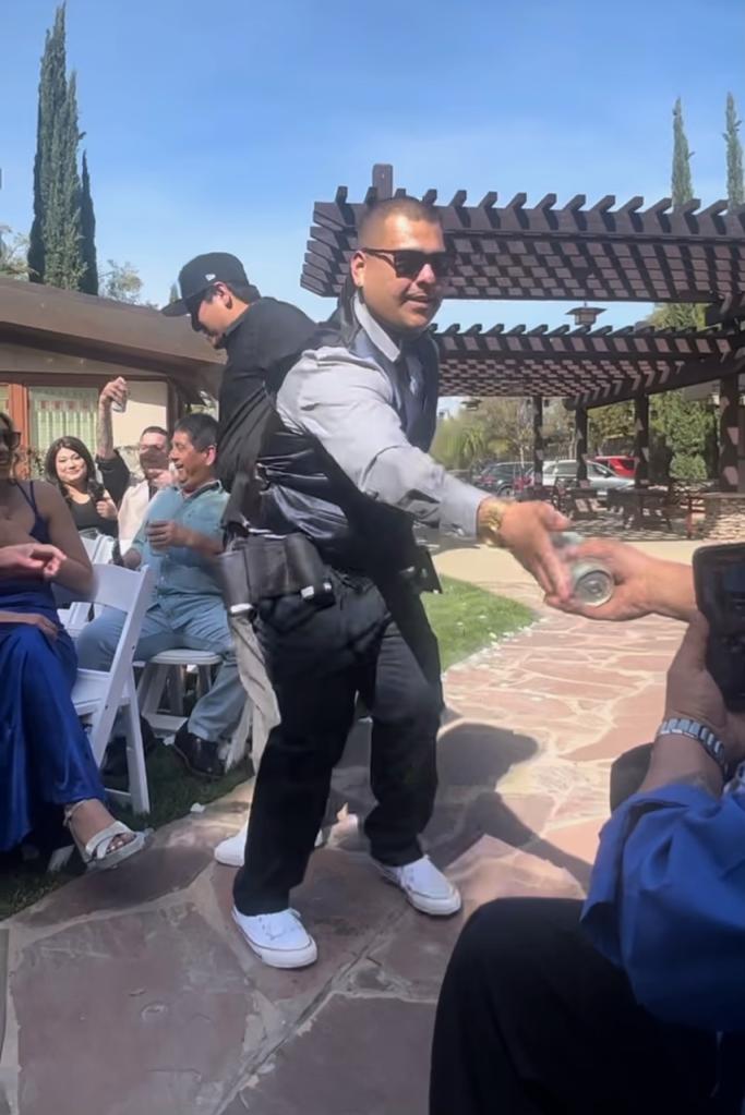 Christian Ayala passing out cans of beer at Armando and Kristina Quiroz's wedding on April 8, 2023 in Temecula, California. 