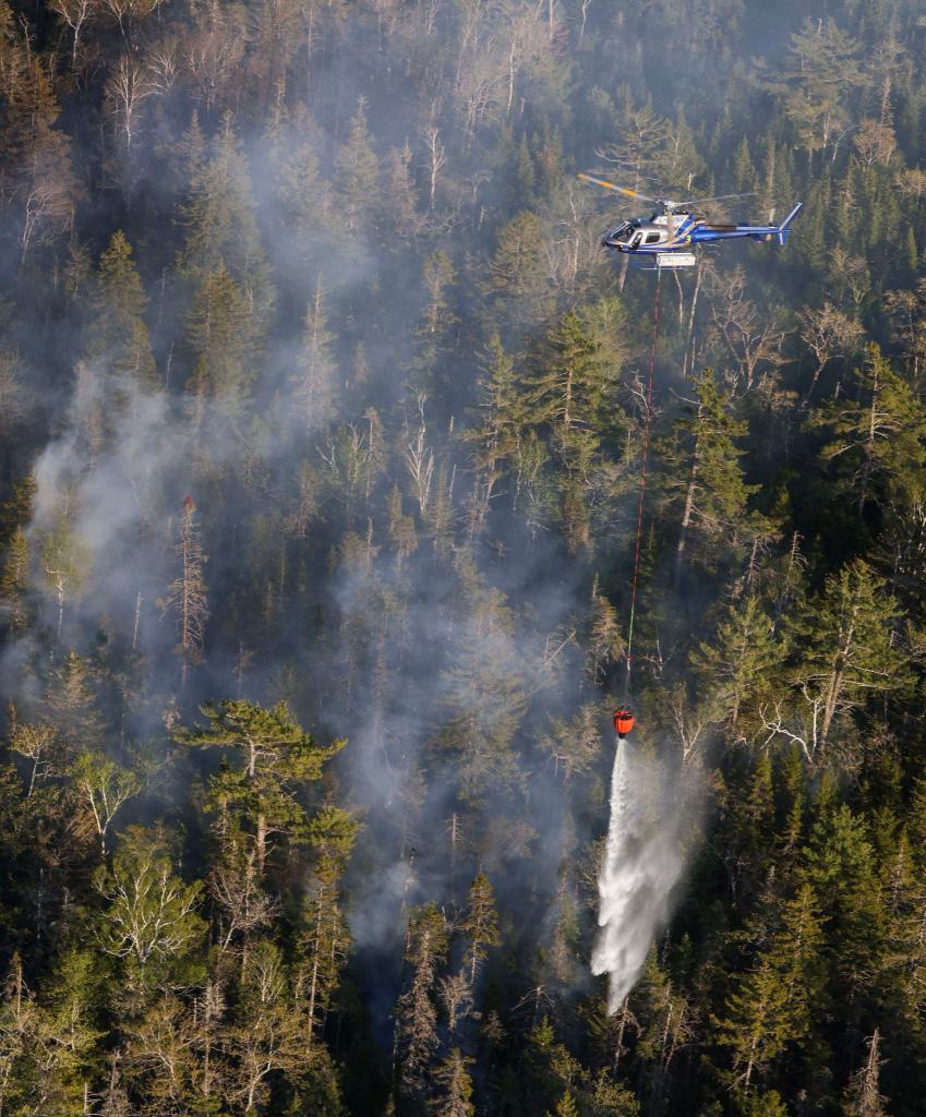 A helicopter drops water on the Tantallon wildfire, west of Halifax.