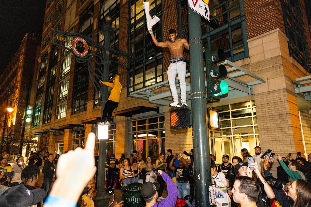 Denver Nuggets fans celebrate in the streets of downtown Denver, Colo., after winning Game 5 of the NBA Finals 