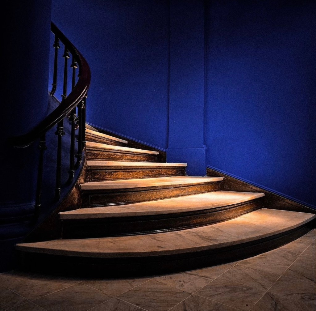 A staircase wrapped by a chic International Klein Blue tone.