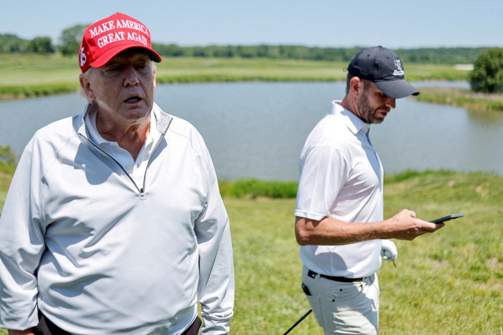 Former U.S. President Donald Trump talks with reporters as he and his son Eric Trump participate in the Pro-Am tournament ahead of the LIV Golf Invitational at the Trump National Golf Club in Sterling, Virginia, U.S. May 25, 2023.  