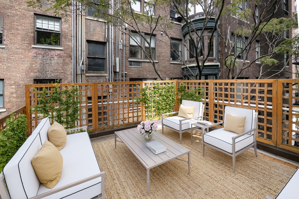 The dwelling looks out to neighboring gardens, even from this outdoor space.