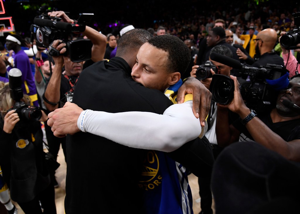 Stephen Curry hugs LeBron James after the Western Conference Semifinal Playoff game on May 12, 2023 in Los Angeles, California.