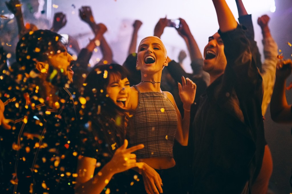 Young friends dancing at a party in a nightclub