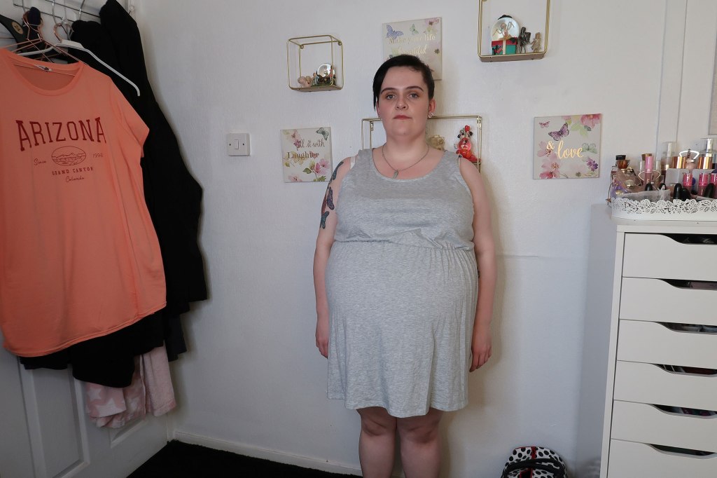 Photo of a woman wearing a gray tank top dress. 