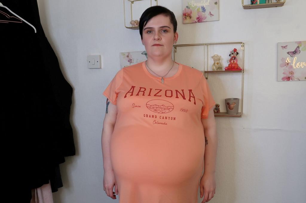 Photo of a woman wearing an orange t-shirt. 