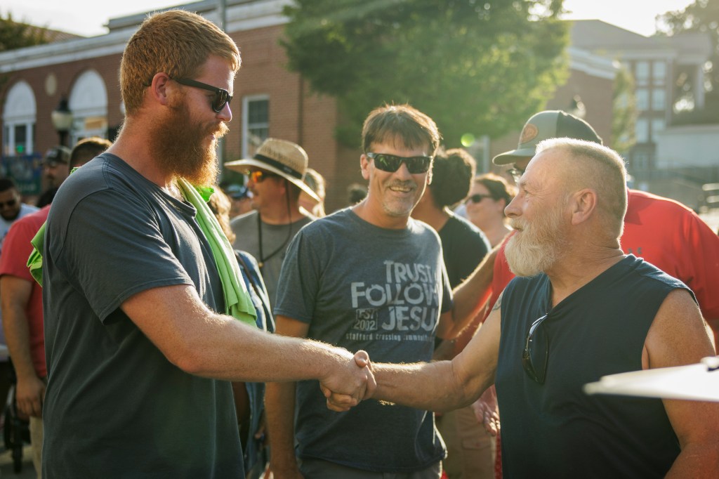 Oliver Anthony shaking hands with a fan