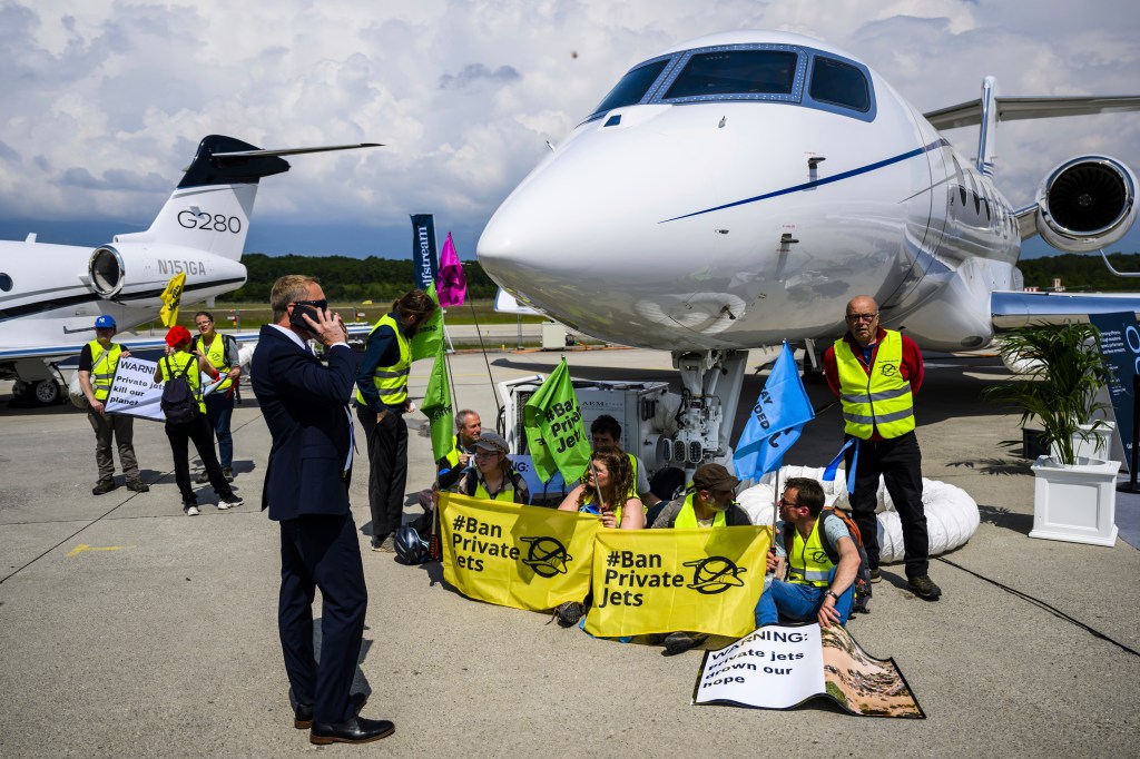 Protesters handcuffed to a private plane