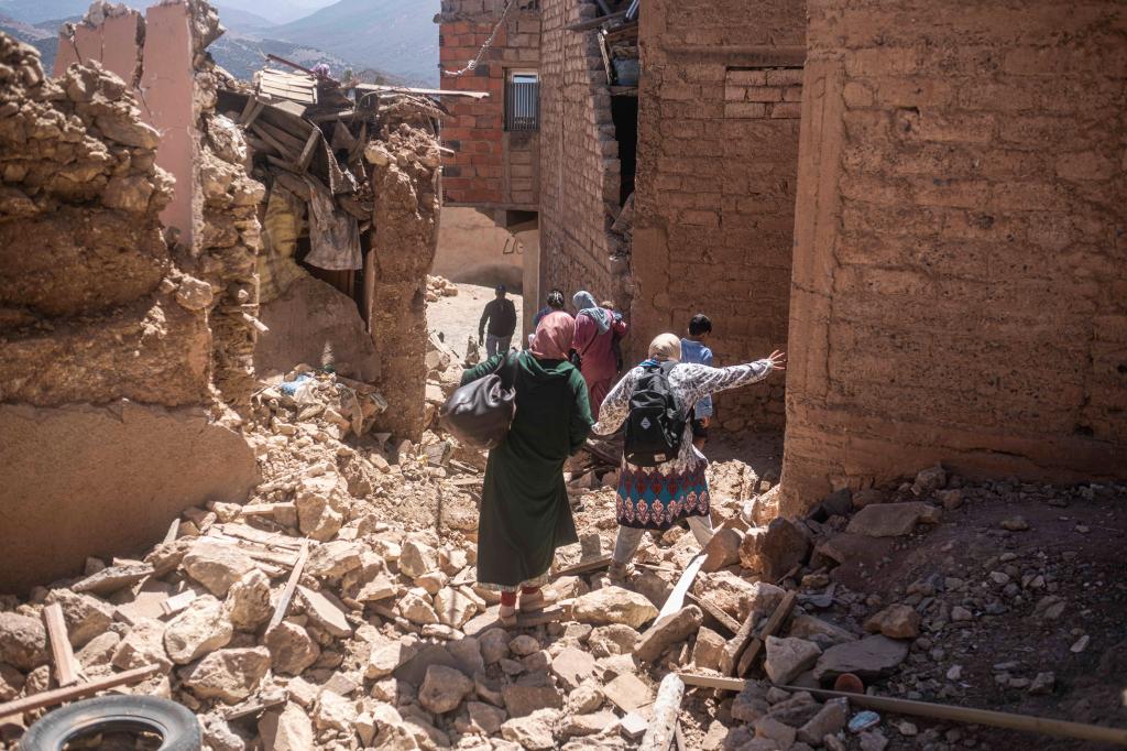 Residents of the village of Moulay Brahim fleeing their destroyed homes.