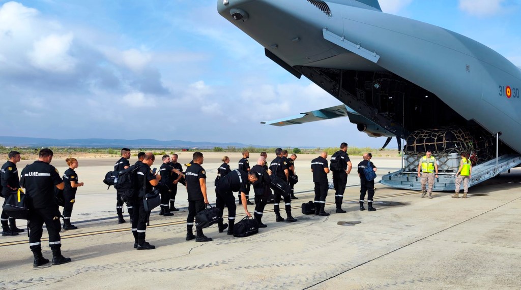 A Spanish military emergency search and rescue unit boarding a plane at a base in Zaragoza to assist in rescue efforts in Morocco.