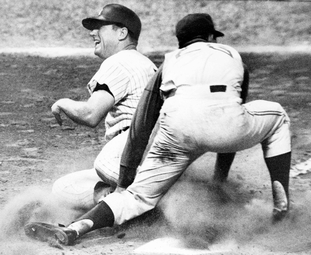 Mickey Mantle has mouth wide in shout of pain as he pulls muscle trying to reach home from second on a passed ball . Injury took place in 4th inning of a second game of double-header in Yankee Stadium, June 23, 1965.