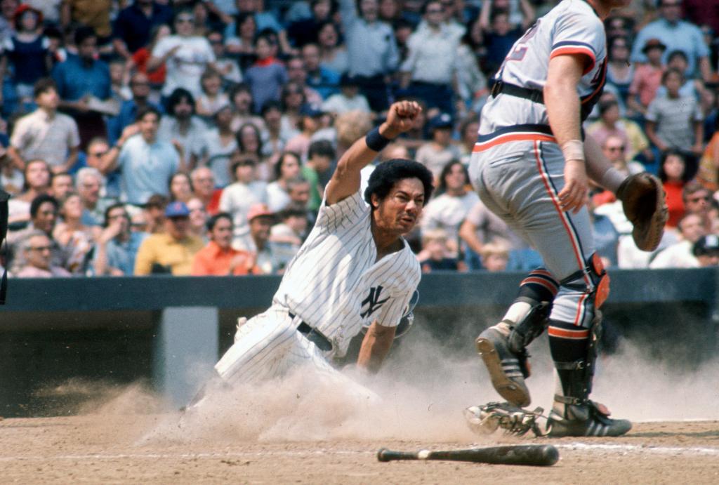 Roy White slides in safe at home against the Detroit Tigers during a game in 1974 at Yankee Stadium in the Bronx.